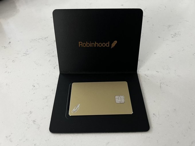 Gold Robinhood card presented in a black box